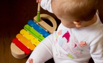 Infant holding a toy